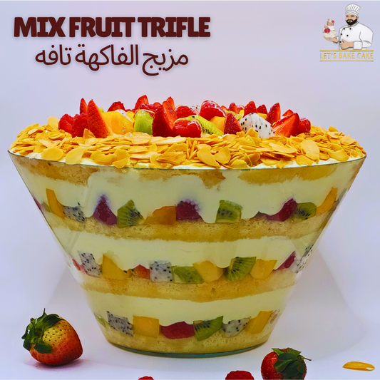 A luxury glass bowl of Mix Fruit Trifle with layers of sponge, custard, kiwi, mango, and dragon fruit topped with almond flakes by Let's Bake Cake Abu Dhabi.