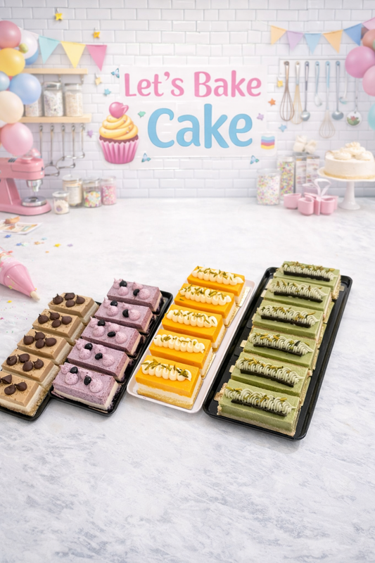 A variety of premium pastries including chocolate, blueberry, mango, and pistachio slices arranged on trays at the Let's Bake Cake studio, Abu Dhabi.