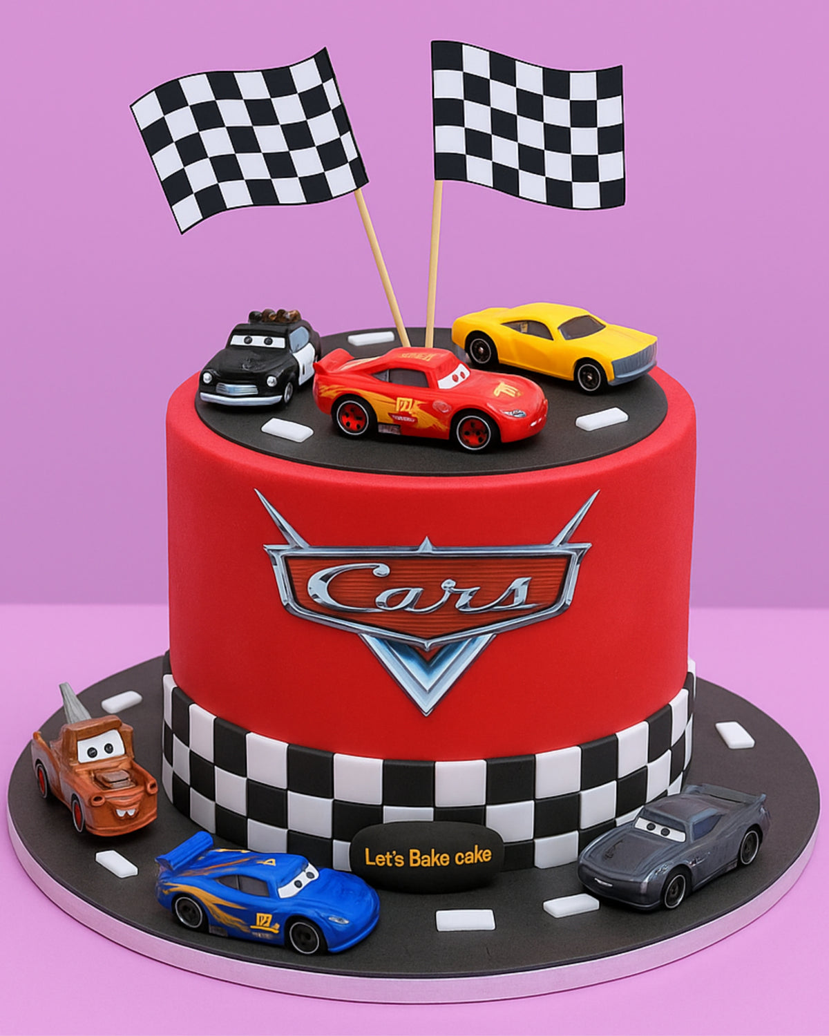 A vibrant red Disney Cars themed birthday cake featuring Lightning McQueen, checkered flags, and a racetrack design by Let's Bake Cake Abu Dhabi.