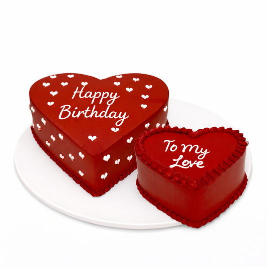 Two heart-shaped red velvet cakes—one large 'Happy Birthday' cake and one mini 'To My Love' bento cake—handcrafted by Let's Bake Cake in Abu Dhabi for romantic celebrations.