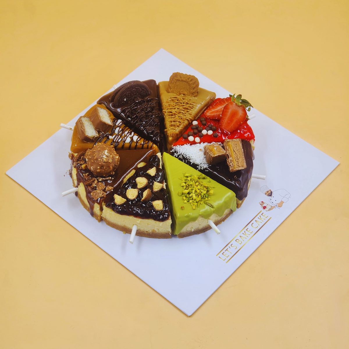 A luxury assorted cheesecake wheel featuring 8 different flavors like Lotus, Oreo, and Pistachio by Let's Bake Cake Abu Dhabi.