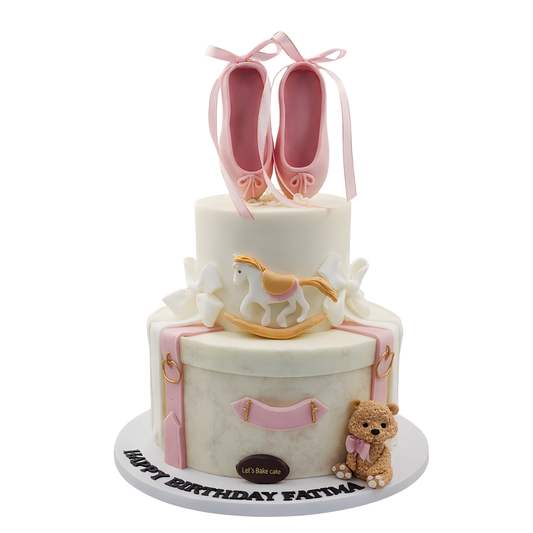A luxury two-tiered pink and white birthday cake with edible ballerina shoes, a rocking horse, and a teddy bear by Let's Bake Cake Abu Dhabi.