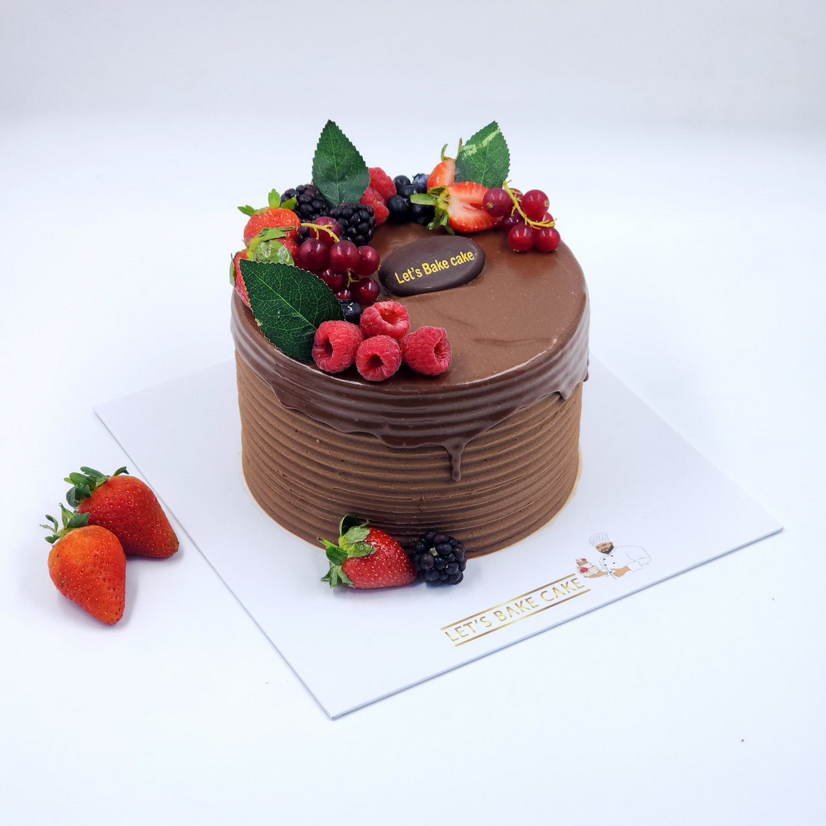 A luxury chocolate cake with horizontal textured frosting, dark chocolate ganache drip, and fresh berries on top by Let's Bake Cake Abu Dhabi.