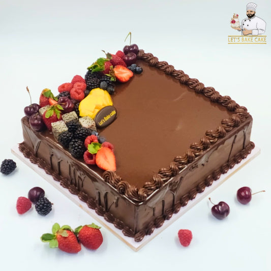 A luxury square chocolate ganache cake topped with fresh cherries, dragon fruit, and mixed berries by Let's Bake Cake Abu Dhabi