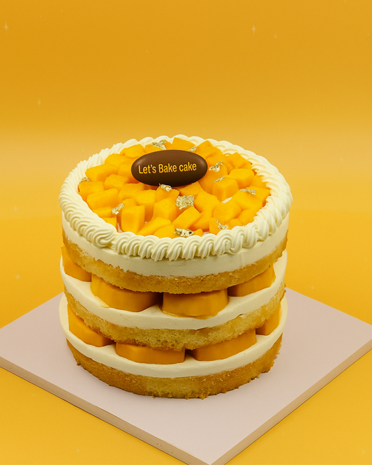 A luxury triple-layer naked cake filled with fresh mango chunks and whipped cream by Let's Bake Cake Abu Dhabi