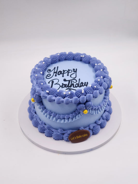 A luxury lavender-purple vintage piped birthday cake with golden pearls and 'Happy Birthday' calligraphy by Let's Bake Cake Abu Dhabi.