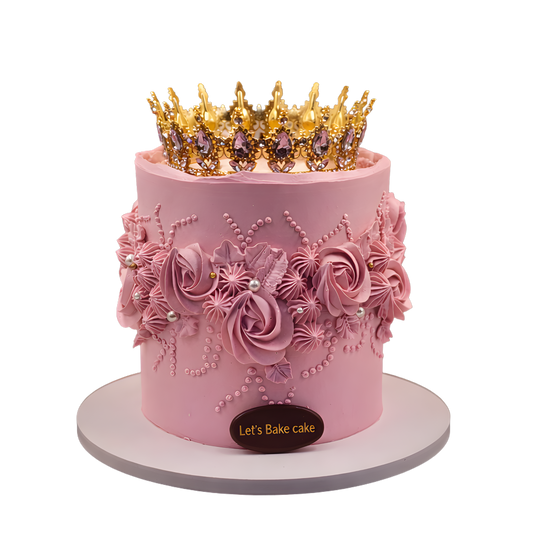 A luxury pink birthday cake with detailed floral piping, edible pearls, and a large crystal gold crown by Let's Bake Cake Abu Dhabi.