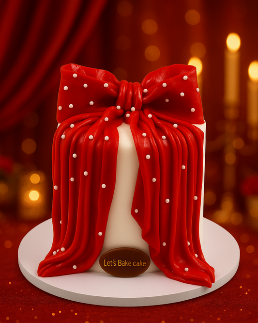 A luxury white cake featuring dramatic red fondant drapes, an oversized bow, and pearl detailing by Let's Bake Cake Abu Dhabi