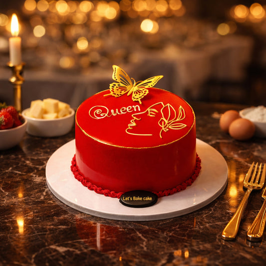 A luxury red mirror-glazed cake with a gold butterfly and 'Queen' written in gold line-art, set on a marble table with candles and gold cutlery, by Let's Bake Cake Abu Dhabi.