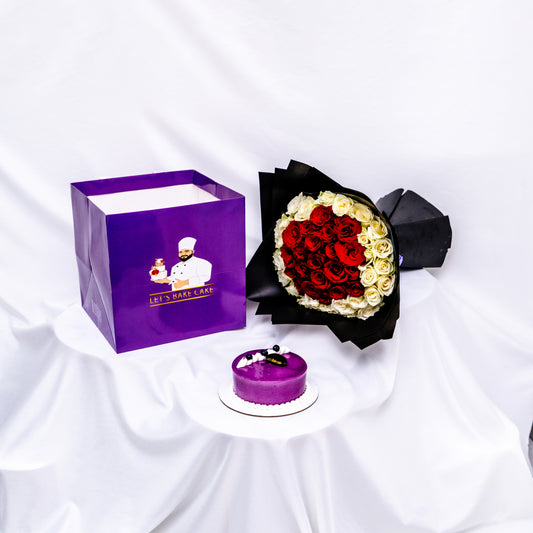 A premium luxury gift set featuring a heart-shaped red and white rose bouquet in black wrapping, a signature purple glazed cake, and a branded 'Let's Bake Cake' purple gift bag on a white silk background, Abu Dhabi.