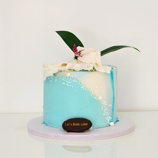A luxury sky blue and ivory cake decorated with a cascade of pearls and a hand-crafted white floral drape by Let's Bake Cake Abu Dhabi.
