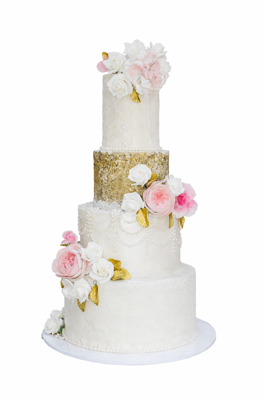 Luxury 4-tier wedding cake featuring a gold sequin tier, elegant pearl draping, and fresh pink and white roses with gold leaves, handcrafted by Let's Bake Cake in Abu Dhabi